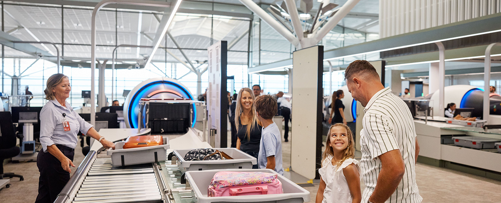 Family undergoing passenger screening at International Terminal