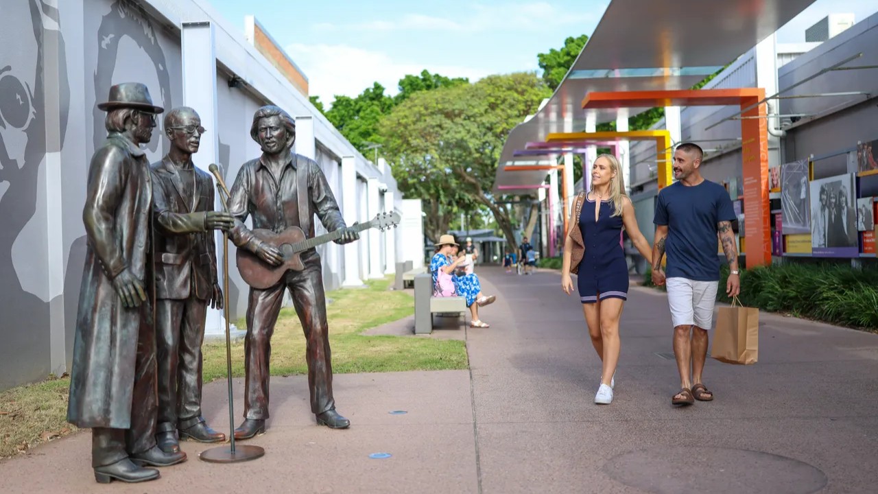 Two people walking down Bee Gees way