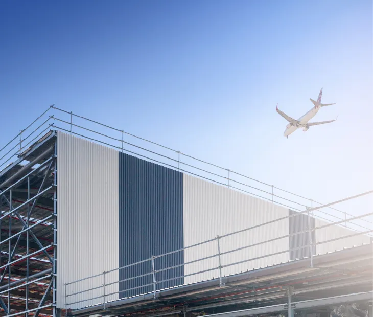 Plane flying over building - Brisbane Airport
