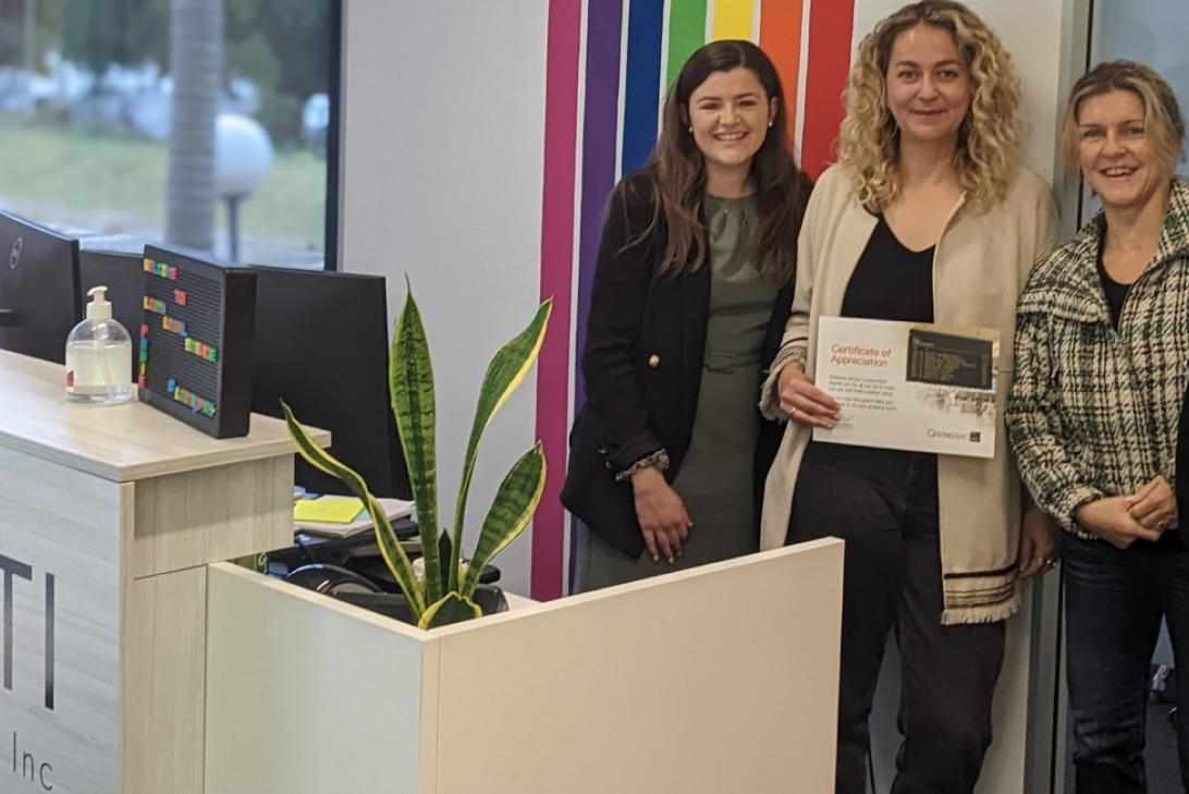 Picture of Amelia Burr with members of the LGBTI Legal Service