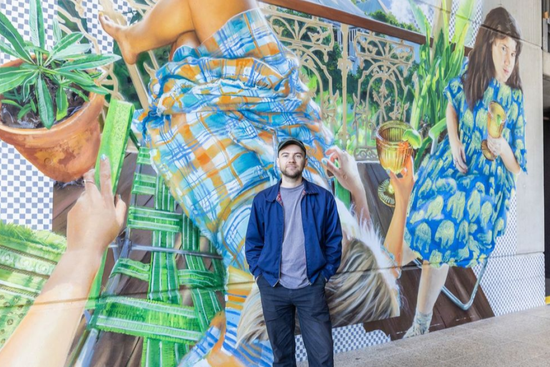 Gus Eagleton infront of artwork