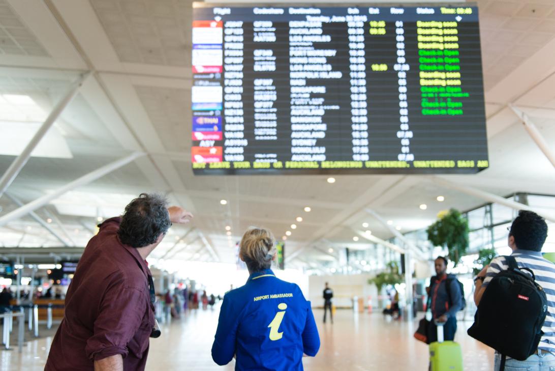 Airport Ambassador assisting someone at the International Terminal